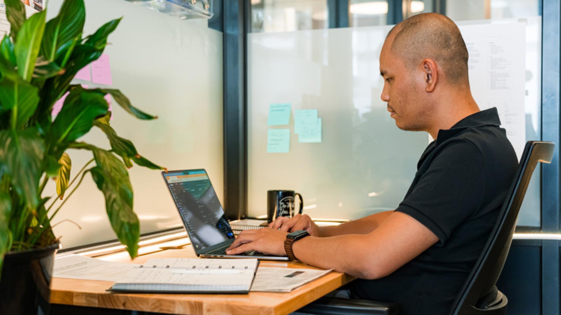 Man working on the computer looking for resources. 